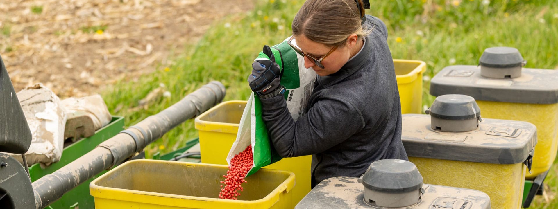 Liqui-Grow employee filling a bin with seed.