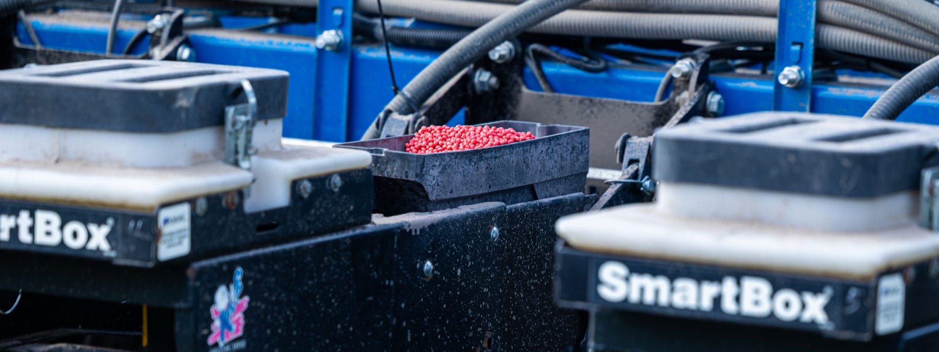 Bins full of seed with fertilizer applied.
